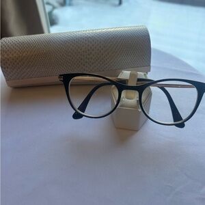 Jimmy Choo black and gold glasses.